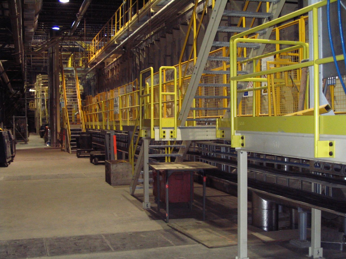 A walkway with guardrail located along a press.